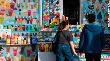 People buy ice cream from a truck in January in Washington. Up and down the east coast, residents are enjoying spring-like temperatures into the 60s in what should feel like winter.