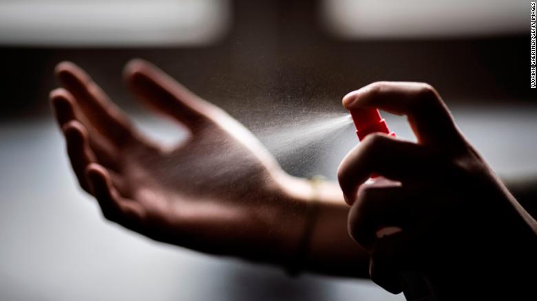 In this photo illustration, a woman sprays disinfectant onto her hands in Berlin, Germany, on February 26. As the novel coronavirus spreads across Asia, people have rushed to stock up on sanitation and cleaning products. In major cities like Hong Kong, stores sold out of hand sanitizer, toilet rolls, face masks, disinfecting wipes, and more.