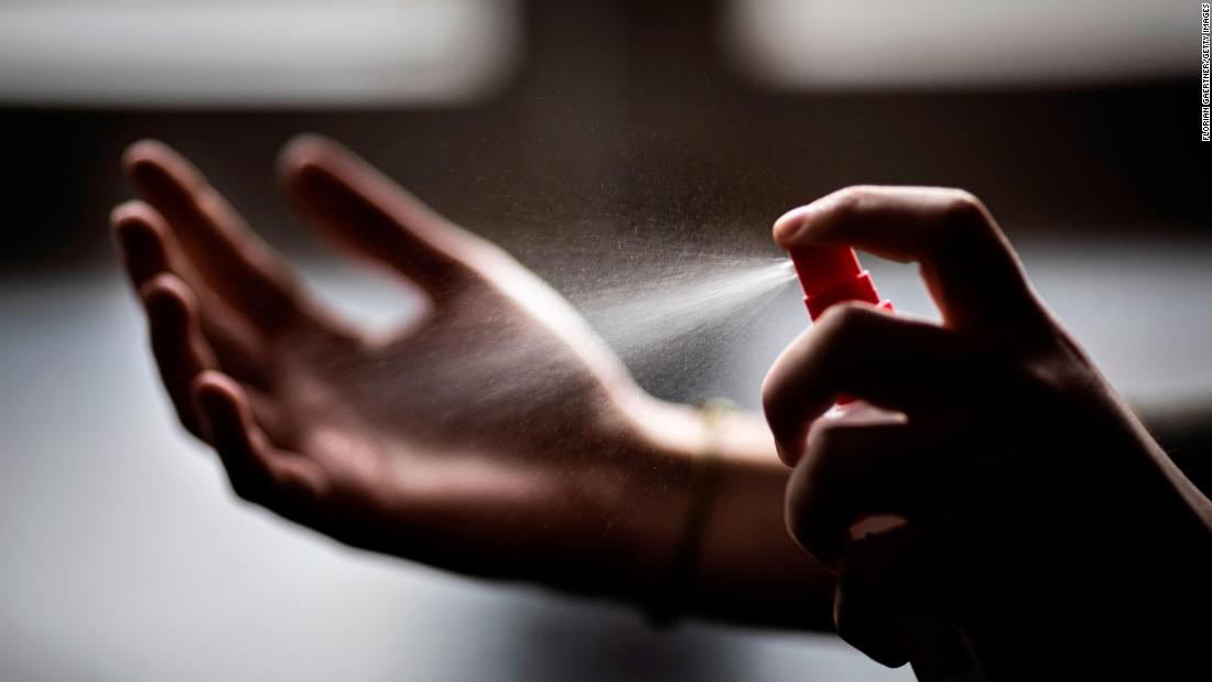In this photo illustration, a woman sprays disinfectant onto her hands in Berlin, Germany, on February 26. As the novel coronavirus spreads across Asia, people have rushed to stock up on sanitation and cleaning products. In major cities like Hong Kong, stores sold out of hand sanitizer, toilet rolls, face masks, disinfecting wipes, and more.