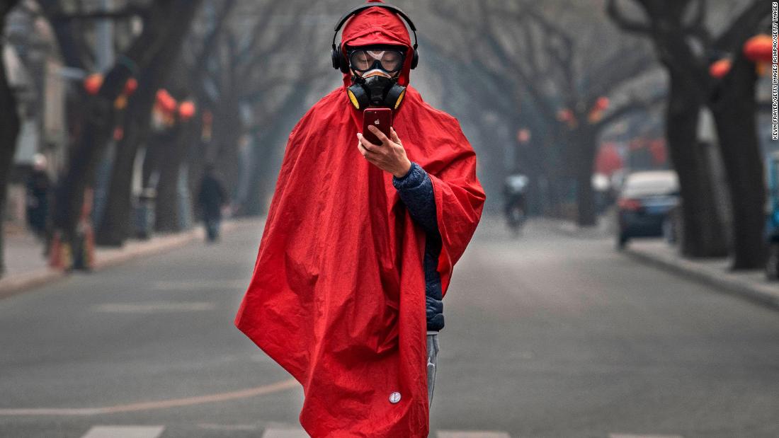A Chinese man wears a protective mask, goggles and coat on a nearly empty street on January 26 in Beijing, China. The outbreak hit during Chinese New Year -- China&#39;s busiest annual travel season. This year, celebrations were canceled, travel restrictions were implemented, and the typical festive atmosphere was replaced by one of fear and caution.
