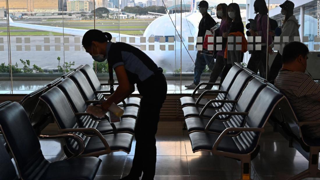 A worker at Manila&#39;s international airport cleaning chairs at the boarding area on February 23. The Philippines has three confirmed cases and one death from the coronavirus. The country has issued travel restrictions in response to the Asia outbreak; most recently, it announced a ban on travelers from the North Gyeongsang Province of South Korea, where numbers of cases have been climbing.