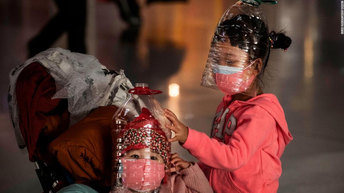 Chinese children wear plastic bottles as makeshift homemade protection at the airport in Beijing on January 30. People in China aren&#39;t taking any chances. Apart from just face masks, they have turned to other ways to protect themselves from the virus in public, like wearing full-body plastic ponchos, shower caps, goggles, gloves, and more.