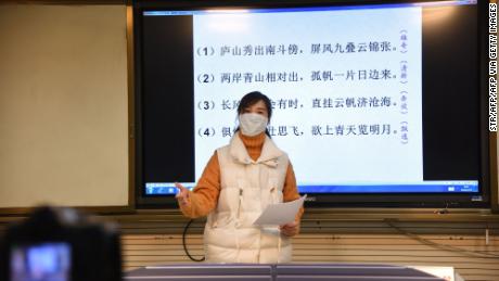 A teacher gives a lecture in front of a camera during an online class at a middle school in Donghai in China&#39;s eastern Jiangsu province on February 17, 2020. 