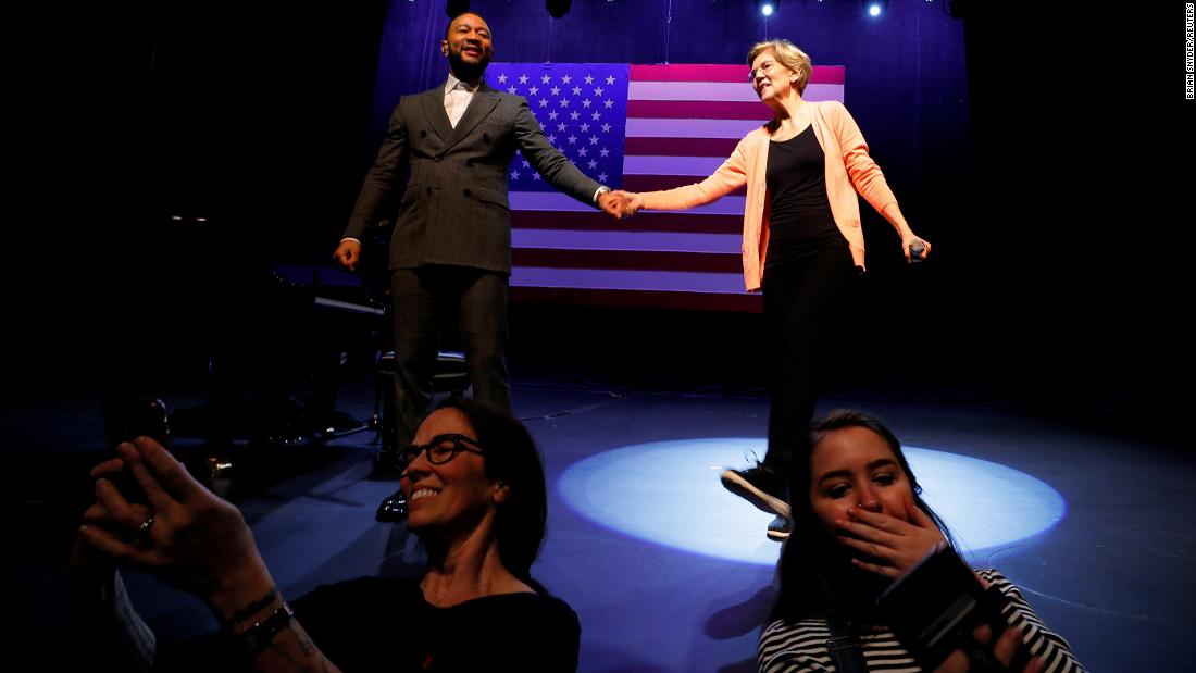 People take photos as Warren is joined by musician John Legend at a Get Out the Vote event in Charleston on Wednesday. 