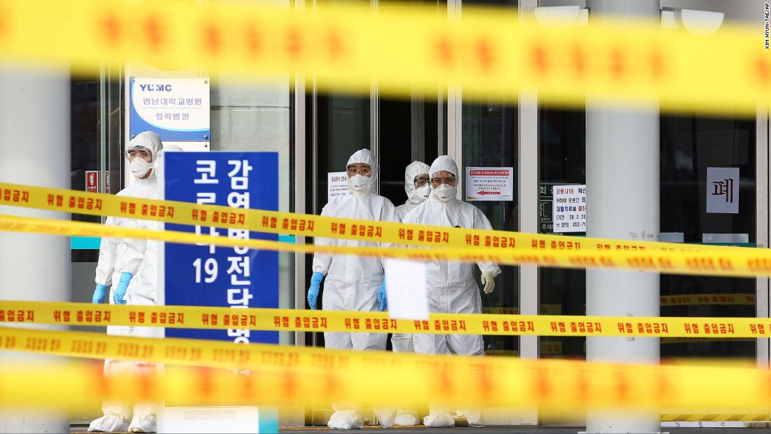 Medical staff stand outside a hospital in Daegu, South Korea, on March 1, 2020.