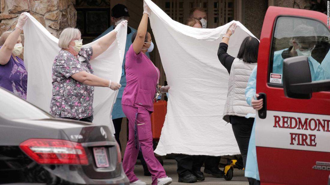 Healthcare workers transfer a patient at the Life Care Center in Kirkland, Washington, on March 1. The long-term care facility is linked to confirmed coronavirus cases.