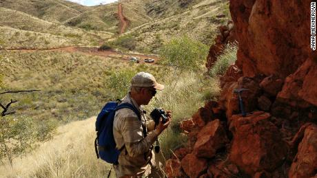 Benjamin Johnson inspects rock at Panorama. This was once an ancient hydrothermal vent.