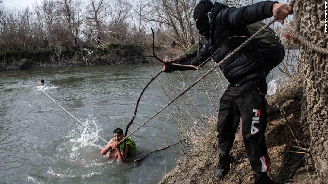 Migrants are rescued from the Evros river after trying to cross from Turkey into Greece on March 1.