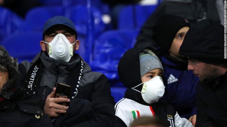 Juventus fans wear protective masks during their side&#39;s Champions League clash against Lyon.