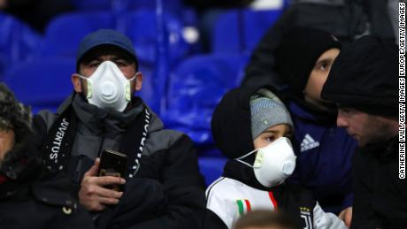 Juventus fans wear protective masks during their side&#39;s Champions League clash against Lyon.