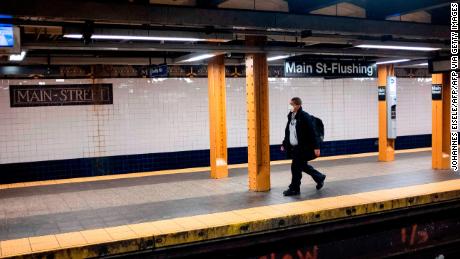 A man wears a face mask on a subway plattform in Flushing, Queens. 