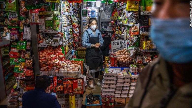 A shopkeeper waits for customers at a market in Beijing on March 4.