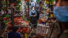 A shopkeeper waits for customers at a market in Beijing on March 4.
