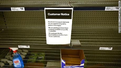 A notice posted on empty shelves of hand saniti
zer in a supermarket in Sydney on Wednesday.