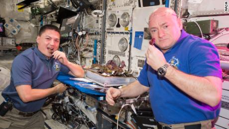 Astronauts Scott Kelly and Kjell Lindgren taste the lettuce grown onboard the station.