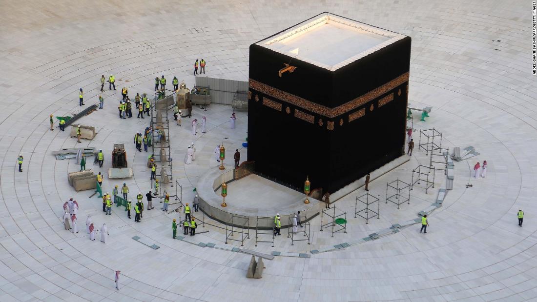 Municipal workers are seen at the Kaaba, inside Mecca&#39;s Grand Mosque. Saudi Arabia emptied Islam&#39;s holiest site for sterilization over coronavirus fears, an unprecedented move after the kingdom suspended the year-round Umrah pilgrimage.