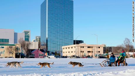 A mushing team circles around Delaney Park in downtown Anchorage, Alaska on March 5, 2020. 