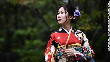 This picture taken on October 21, 2019 shows a woman dressed in a kimono visiting the Senso-ji temple in Tokyo. - The Japan 2019 Rugby World Cup tournament will be held from September 20 to November 2. (Photo by Anne-Christine POUJOULAT / AFP) / The erroneous mention[s] appearing in the metadata of this photo by Anne-Christine POUJOULAT has been modified in AFP systems in the following manner: [Senso-ji temple] instead of [Senjo-ji temple]. Please immediately remove the erroneous mention[s] from all your online services and delete it (them) from your servers. If you have been authorized by AFP to distribute it (them) to third parties, please ensure that the same actions are carried out by them. Failure to promptly comply with these instructions will entail liability on your part for any continued or post notification usage. Therefore we thank you very much for all your attention and prompt action. We are sorry for the inconvenience this notification may cause and remain at your disposal for any further information you may require. (Photo by ANNE-CHRISTINE POUJOULAT/AFP via Getty Images)