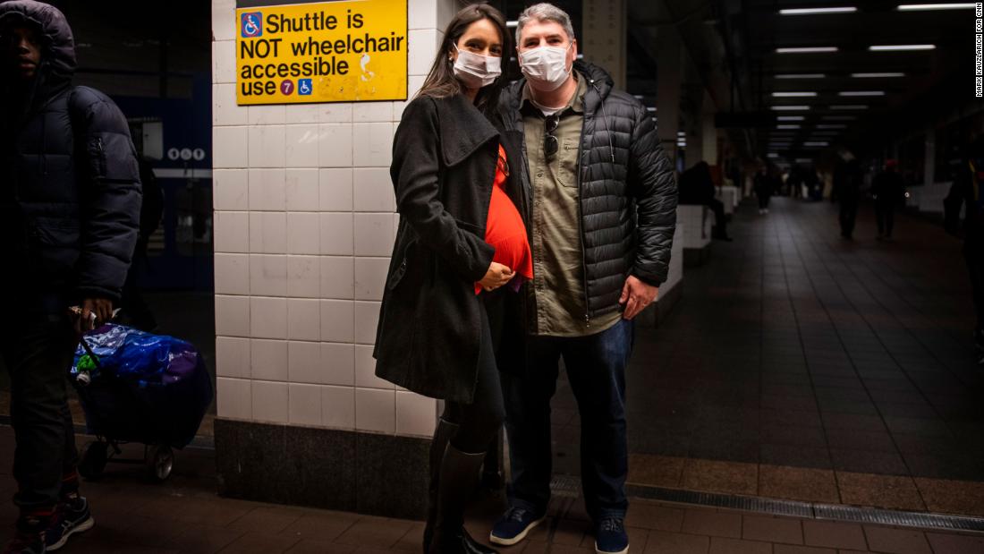 Leonardo Gayer and wife Vanessa, visiting from Brazil, wear surgical masks in the New York subway. 