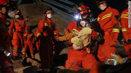 Rescuers carried a young boy from the rubble. 
