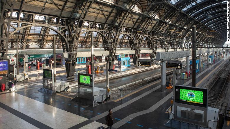 A woman walks in the almost deserted Central Station in Milan on Sunday after the lockdown was imposed overnight.  