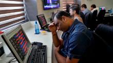 An Indian stockbroker reacts as he watches the Bombay Stock Exchange (BSE) index on a trading terminal in Mumbai, India, Monday, March 9, 2020. Global stock markets and oil prices plunged Monday after a squabble among crude producers jolted investors who already were on edge about the surging costs of a virus outbreak. India's Sensex retreated 6.2% to 35,255.73. (AP Photo/Rajanish Kakade)