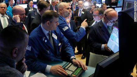 Specialist Philip Finale, background center, works with traders on the floor of the New York Stock Exchange, Monday, March 9, 2020. The Dow Jones Industrial Average plummeted 1,500 points, or 6%, following similar drops in Europe after a fight among major crude-producing countries jolted investors already on edge about the widening fallout from the outbreak of the new coronavirus. (AP Photo/Richard Drew)