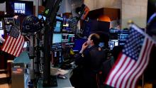 Trader Jonathan Greco prepares for the day's activity on the floor of the New York Stock Exchange, Monday, March 9, 2020. Trading in Wall Street futures has been halted after they fell by more than the daily limit of 5%. (AP Photo/Richard Drew)