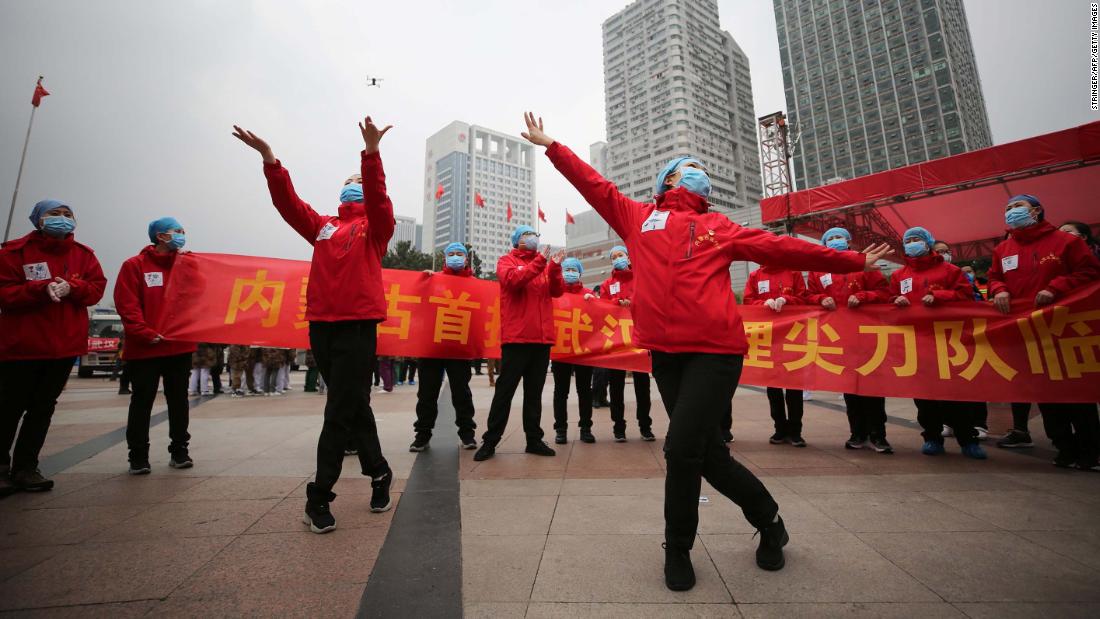 Medical staff in Wuhan, China, celebrate after all coronavirus patients were discharged from a temporary hospital on March 9, 2020.