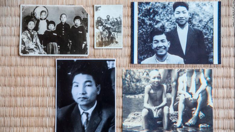 Photos of Iwao Hakamada spread along the tatami mat at his home in Hamamatsu.