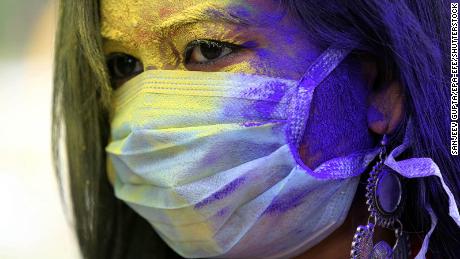 Holi celebrated with face masks and color explosions amid coronavirus fears