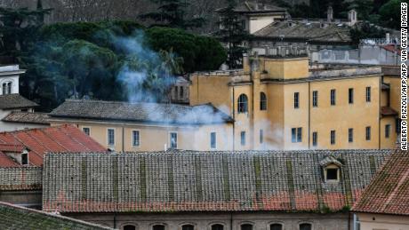 Smoke billows from a rooftop of the Regina Coeli prison in central Rome on Monday.