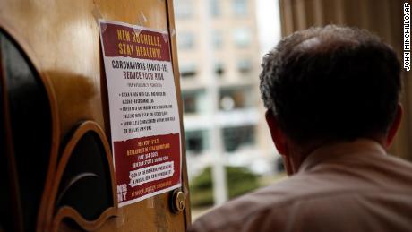 A sign providing instructions on how to reduce the risk of contracting or spreading COVID-19 is hung on the front door of New Rochelle City Hall, Tuesday, March 10, 2020, in New Rochelle, N.Y. State officials are shuttering schools and houses of worship for two weeks in part of the New York City suburb New Rochelle and sending the National Guard there to help respond to what appears to be the nation&#39;s biggest cluster of coronavirus cases. 