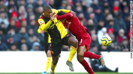 LIVERPOOL, ENGLAND - DECEMBER 14: Christian Kabasele of Watford and Mohamed Salah of Liverpool clash during the Premier League match between Liverpool FC and Watford FC at Anfield on December 14, 2019 in Liverpool, United Kingdom. (Photo by Clive Brunskill/Getty Images)