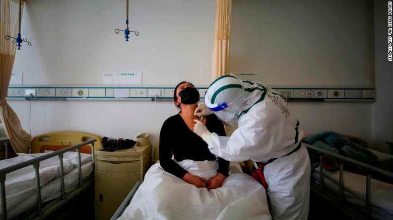 A patient infected by the COVID-19 coronavirus receives acupuncture treatment at Red Cross Hospital in Wuhan, China