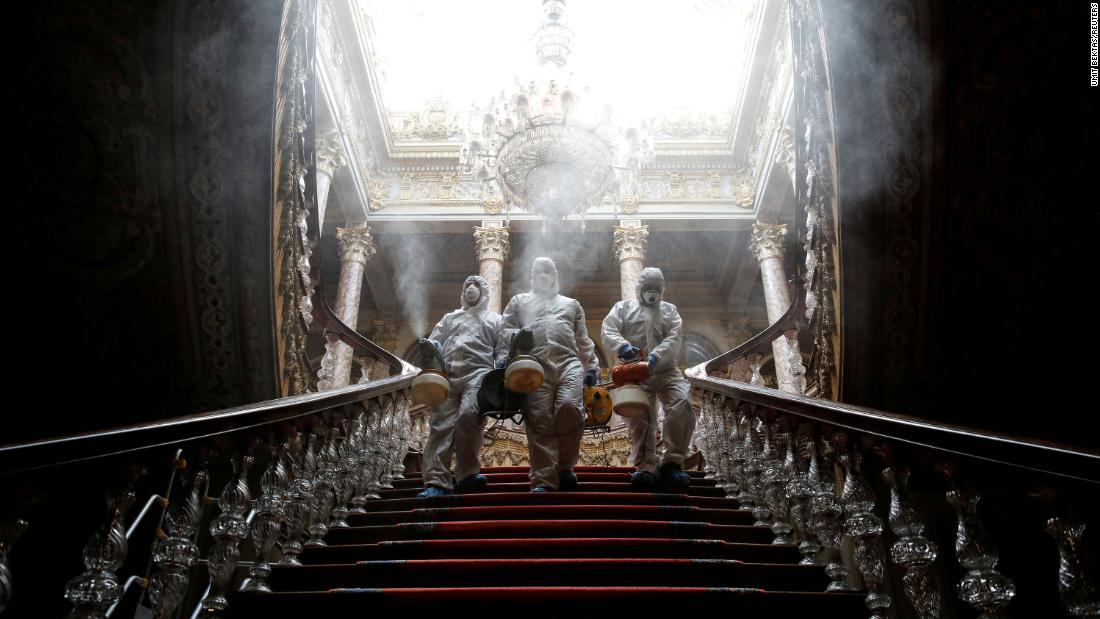 Workers in protective suits disinfect Istanbul&#39;s Dolmabahce Palace on March 11, 2020.