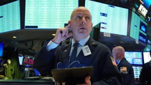 Traders work on the floor at the opening bell of the Dow Industrial Average at the New York Stock Exchange on March 12, 2020 in New York. - Wall Street stocks were deep in the red early Thursday, resuming after a 15-minute suspension as the economic pain from the coronavirus deepens and widens. About 25 minutes into trading, the Dow Jones Industrial Average was at 21,505.07, down more than 2,000 points or 8.7 percent.The broad-based S&P 500 tumbled 8.1 percent to 2,519.43, while the tech-rich Nasdaq Composite Index shed 7.9 percent to 7,323.31. (Photo by Bryan R. Smith / AFP) (Photo by BRYAN R. SMITH/AFP via Getty Images)