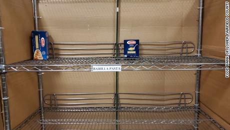 Lone boxes of pasta sit on the shelves at the Food Bank of Lower Fairfield County in Connecticut.