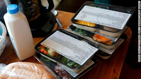 Volunteers at Meals on Wheels deliver food to a man in Portland.