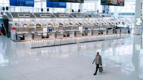 A man walks past the closed Air France counters at the Terminal 1 section at John F. Kennedy International Airport on March 12, 2020 in New York City. - US President Donald Trump announced a shock 30-day ban on travel from mainland Europe over the coronavirus pandemic that has sparked unprecedented lockdowns, widespread panic and another financial market meltdown Thursday.The announcement came as China, where the outbreak that first emerged in December, showed a dramatic drop in new cases and claimed &quot;the peak&quot; of the epidemic had passed. (Photo by Kena Betancur / AFP) (Photo by KENA BETANCUR/AFP via Getty Images)