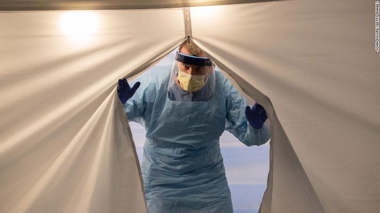 A nurse wearing protective clothing emerges from a tent at a coronavirus testing center at the University of Washington Medical Center in Seattle on March 13, 2020.