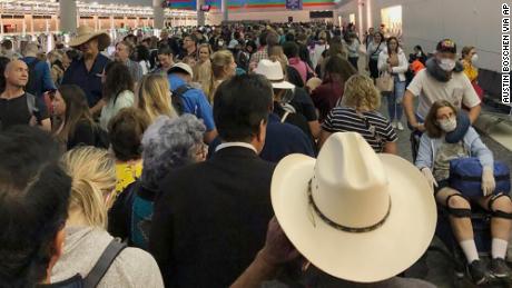 Americans returning from overseas wait hours for coronavirus screening at airports