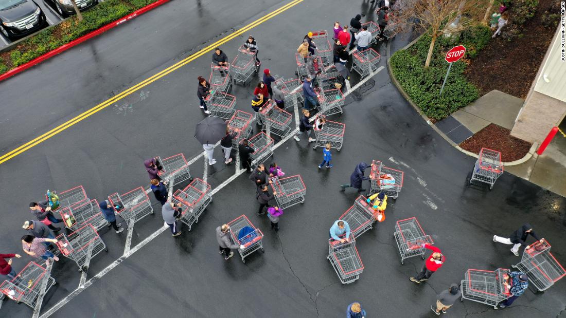 Hundreds of people line up to enter a Costco store on March 14, 2020, in Novato, California. 