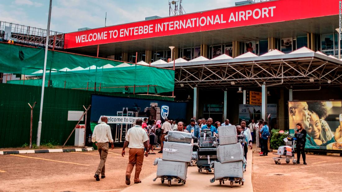 Passengers arriving on international flights leave the international arrivals lobby after they have been screened and cleared for any symptoms of the novel coronavirus at Entebbe Airport on March 3, 2020. - The deadly virus has marched well beyond China&#39;s borders, spreading across Asia and Europe and into Latin America, Africa and the United States. More than 90,000 people have been infected and 3,100 killed since the virus first emerged in China&#39;s Hubei province late last year. (Photo by SUMY SADURNI / AFP) (Photo by SUMY SADURNI/AFP via Getty Images)