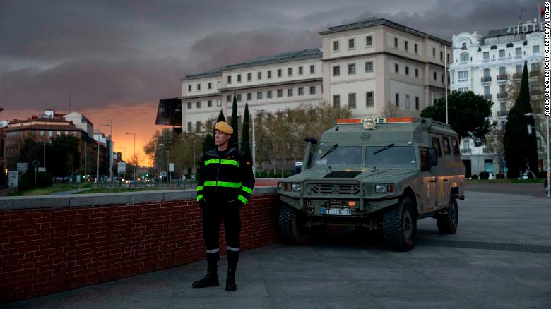 A member of the Spanish Military Emergency Unit (UME) stands guard near Madrid&#39;s Atocha train station on Sunday.