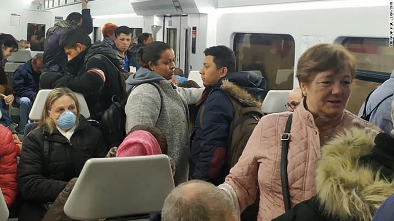 Commuters on a busy train at Madrid&#39;s Atocha train station.