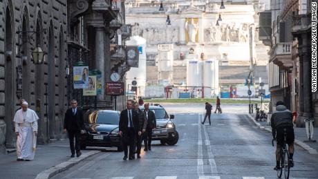 Pope Francis walks along the normally bustling Via del Corso in Rome on March 15, 2020. The street was almost empty because of Italy&#39;s strict coronavirus restrictions.