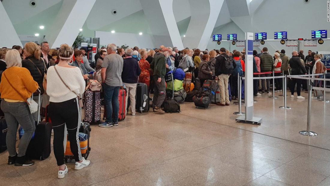 Passengers wait for their flights at Marrakesh Airport in Morocco on March 15, 2020.