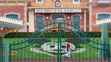 An employee cleans the grounds behind the closed gates of Disneyland Park on the first day of the closure of Disneyland and Disney California Adventure theme parks as fear of the spread of coronavirus continue, in Anaheim, California, on March 14, 2020. - The World Health Organization said March 13, 2020 it was not yet possible to say when the COVID-19 pandemic, which has killed more than 5,000 people worldwide, will peak. &quot;It&#39;s impossible for us to say when this will peak globally,&quot; Maria Van Kerkhove, who heads the WHO&#39;s emerging diseases unit, told a virtual press conference, adding that &quot;we hope that it is sooner rather than later&quot;. (Photo by DAVID MCNEW / AFP) (Photo by DAVID MCNEW/AFP via Getty Images)