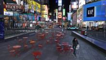 A woman walks through a lightly trafficked Times Square in New York, Monday, March 16, 2020. Bars and restaurants will become takeout-only and businesses from movie theaters and casinos to gyms and beyond will be shuttered Monday night throughout New York, New Jersey and Connecticut because of the coronavirus, the states&#39; governors said. (AP Photo/Seth Wenig)